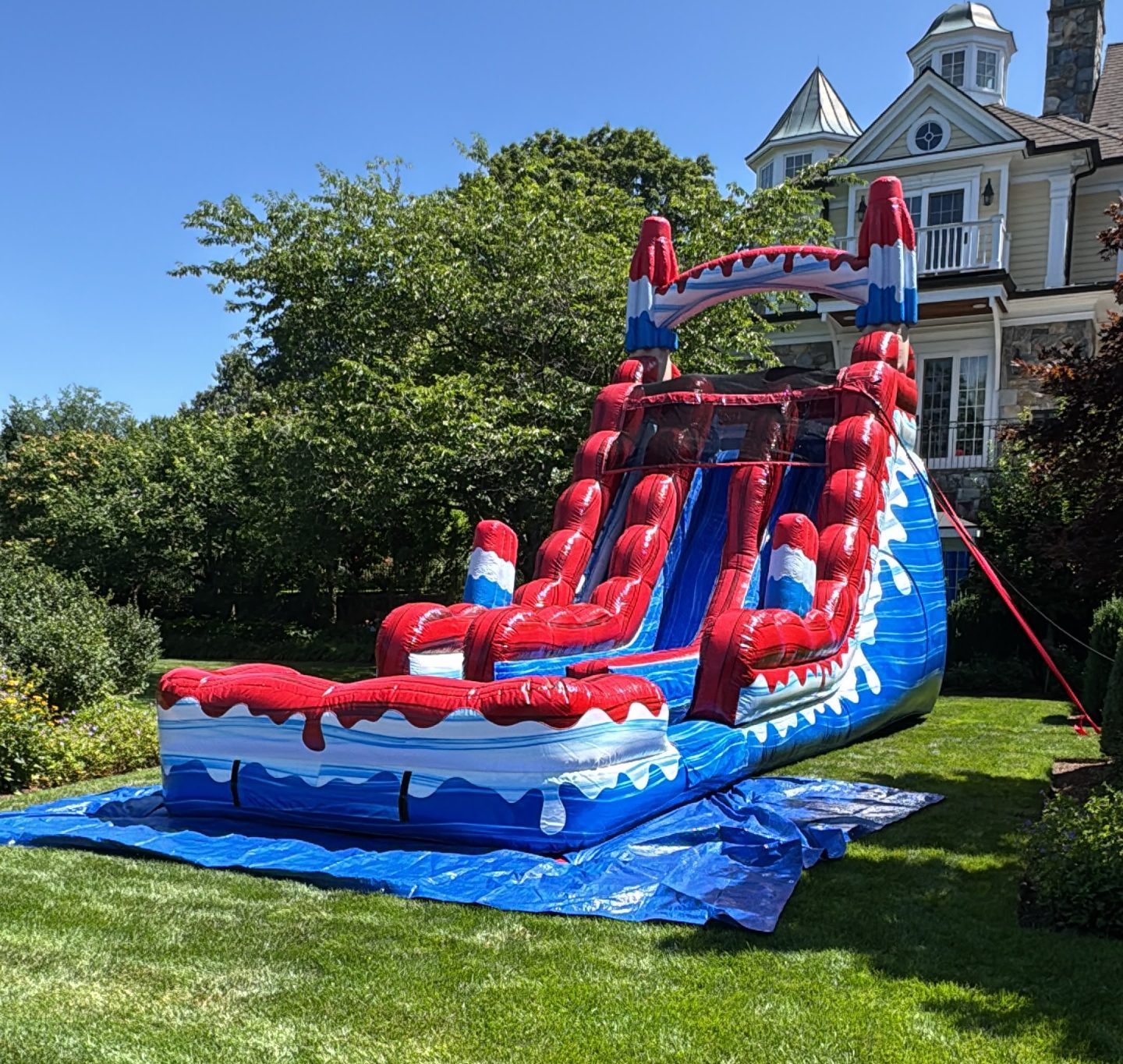 A colorful dual lane waterslide called Popsicle Plunge where riders slide down two side-by-side lanes at a water attraction.